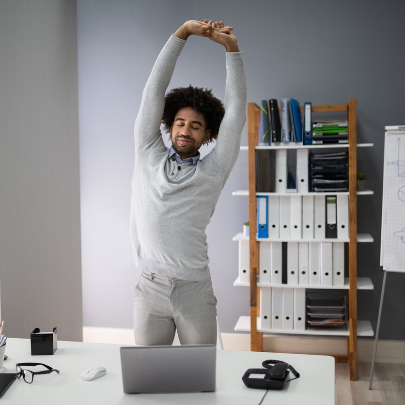 Employee at workstation stretching